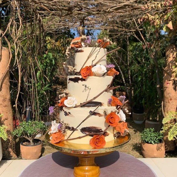 Orange Flowers Creeping On Buttercream Wedding Cake