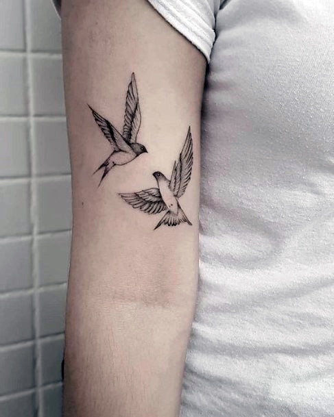 flying birds tattoo arm