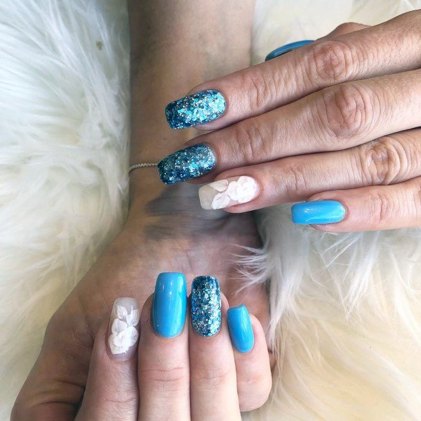 Pale White Petals And Polished Blue Creative Art On Nails For Women