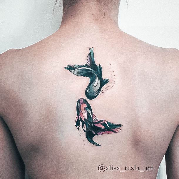 Ravishing Girly Tattoo On Female Fish Swimming Back