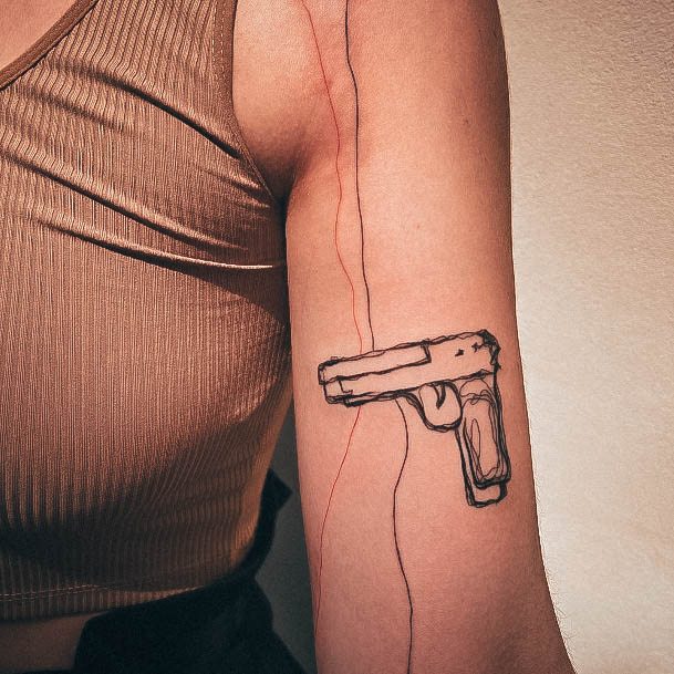 Ravishing Gun Tattoo On Female