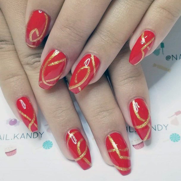 Red Nails With Golden Curved Art On Nails Women