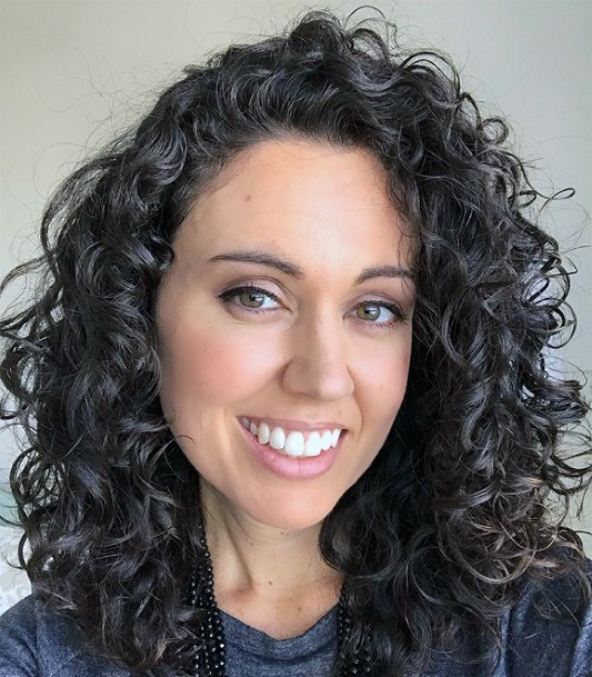 Relaxed Female With Large Dark Natural Tendrils Swept Over Sexy Hair