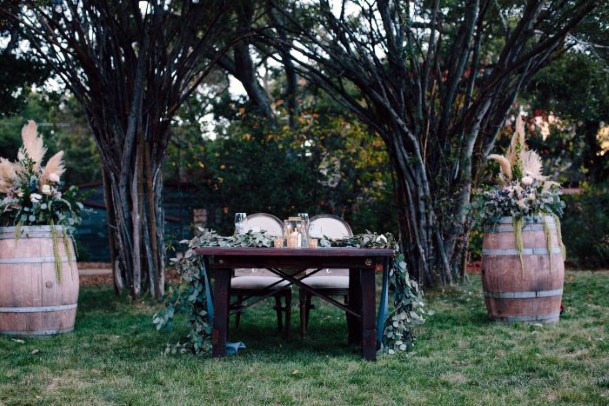 Rustic Wedding Ideas Outdoor Reception Wooden Sweetheart Table Trees Backdrop