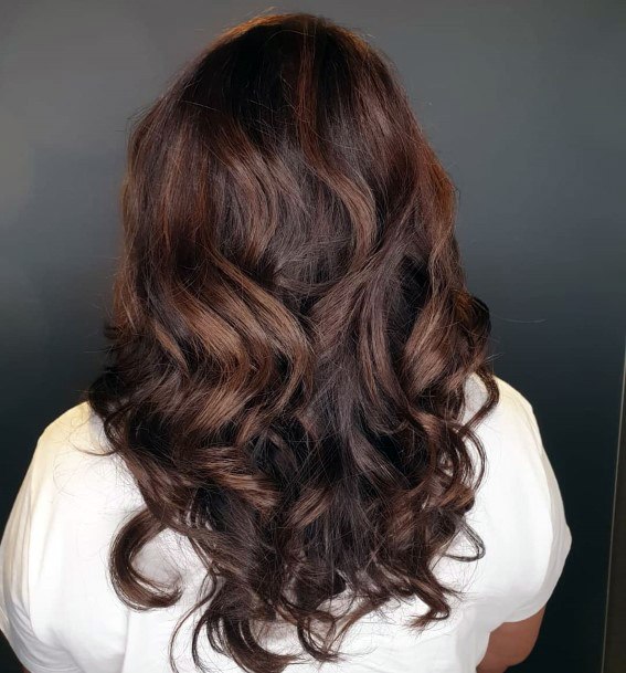 Sexy And Bold Red Toned Highlights In Bouncy And Voluminous Curled Girls Hairstyle