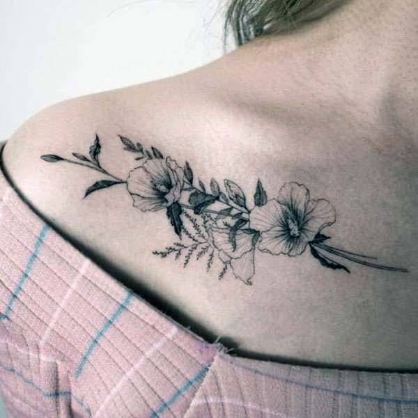 Shaded Grey Flower Tattoo On Womens Collarbone