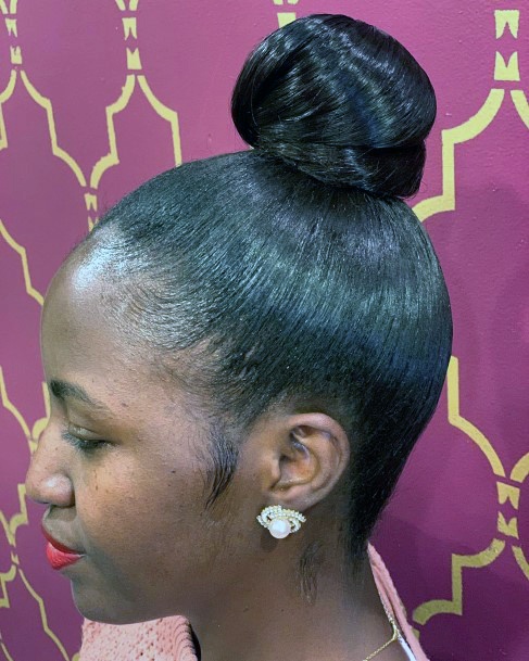 Side View Of Woman In Tight Top Knot Hairstyles