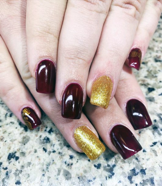 Sleek Maroon And Fancy Gold Shimmering Nail Design Inspiration For Women