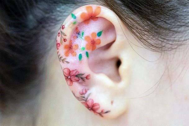 Smattering Of Small Cute Flowers Womens Ears Tattoo