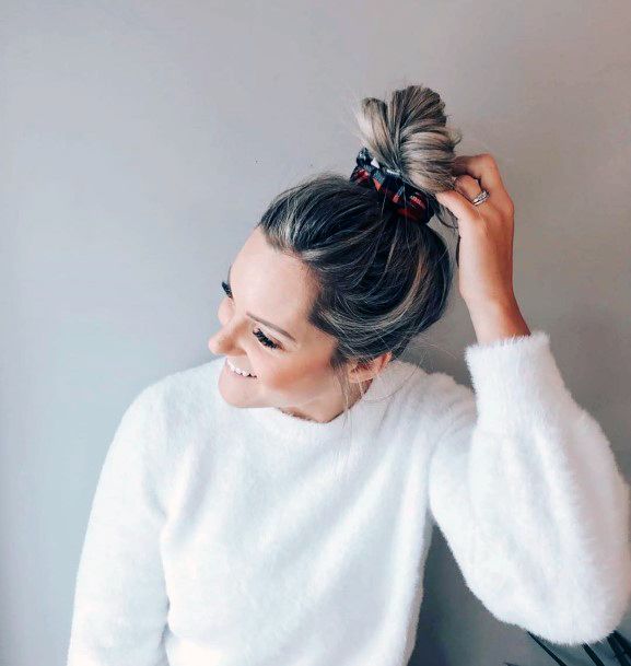 Smiling Woman With A Top Knot Hairstyle With A Bow