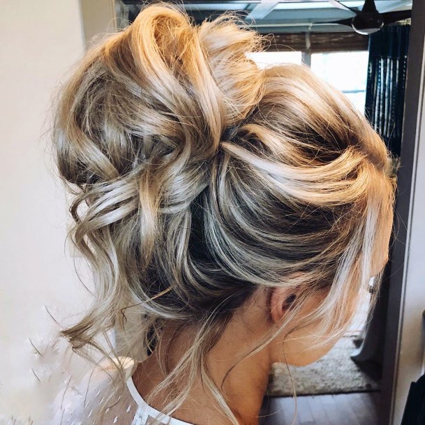 Sophisticated Messy Topknot Hairstyle For Women With Loose Front Pieces