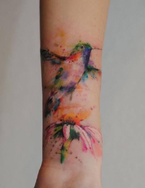 Splotchy Colored Bird And Flower Tattoo Womens Forearms