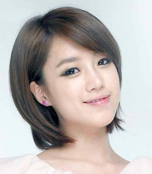 Square Faced Girl With Bob Hairstyle And Side Sweeping Bangs