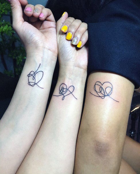 Squiggly Heart Sister Tattoo On Wrist