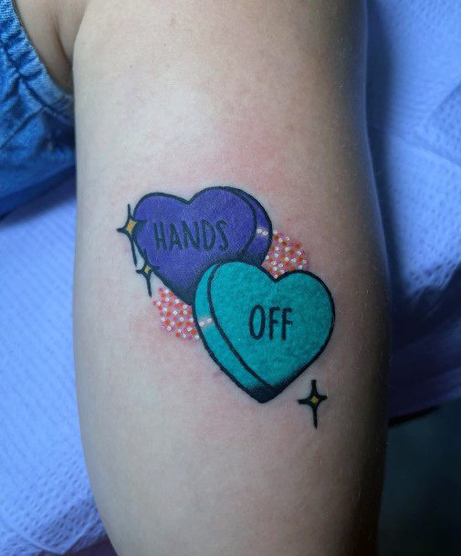 Stunning Candy Heart Tattoo On Lady