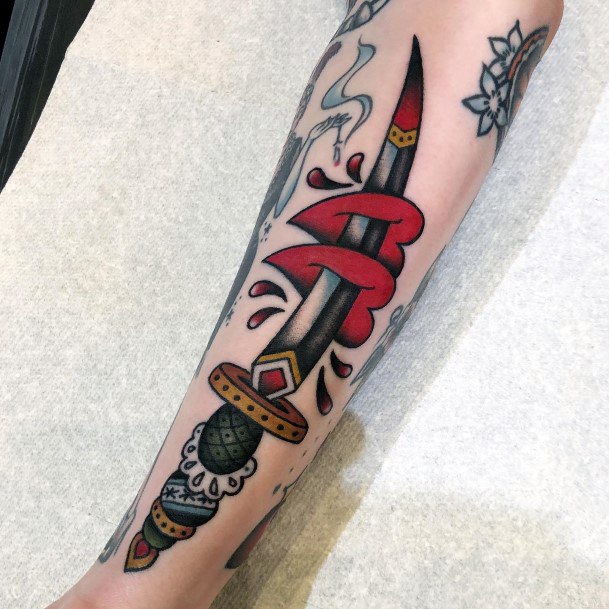 Stunning Dagger Heart Tattoo On Lady