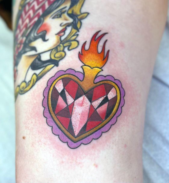 Stunning Girls Flaming Heart Tattoos