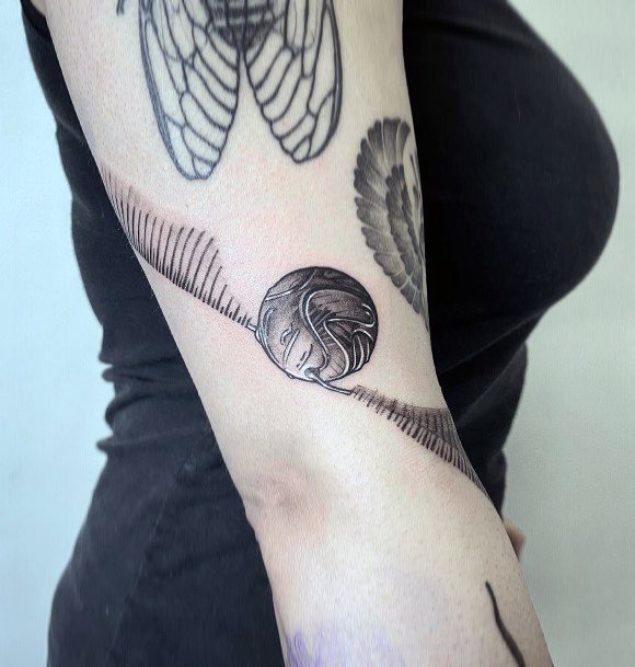 Stunning Golden Snitch Tattoo On Lady