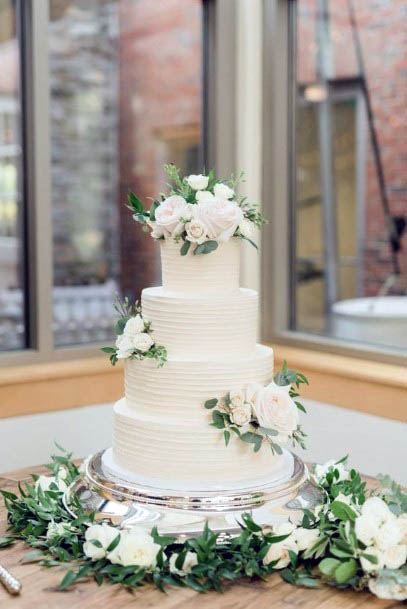 Three Tiered White Wedding Cake With Flowers Art