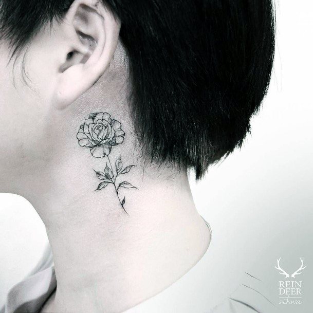 Tiny Black Flower With Leafy Stem Womens Neck Tattoo