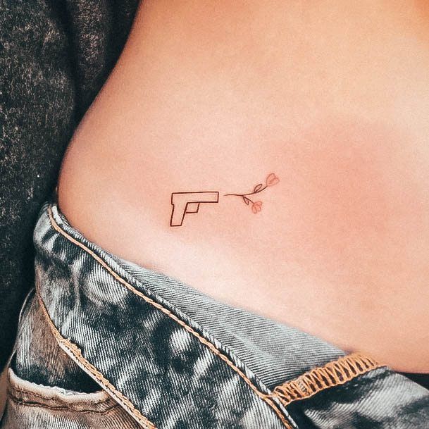 gun tattoos on hips for women