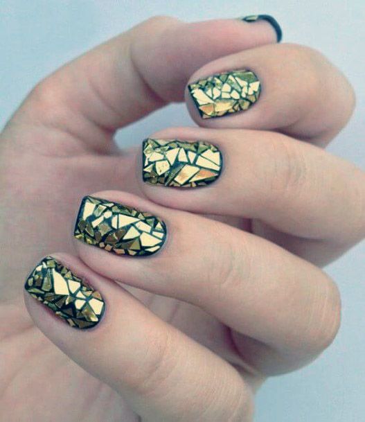 Triangular Gold Flakes On Top Of Black Nail Polish