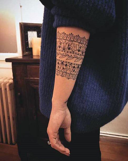 Tribal Ribbon Tattoo On Arms Of Women