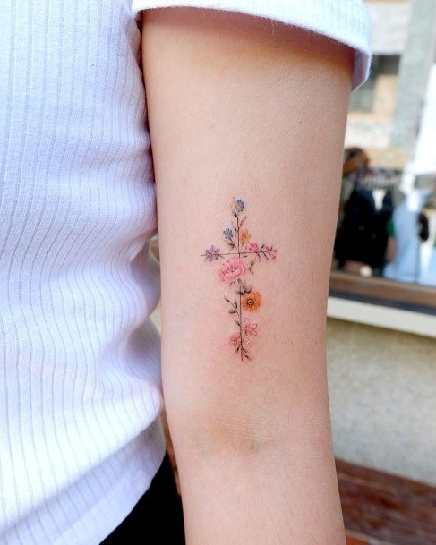 Warm Colored Flowers And Cross Tattoo Womens Arms