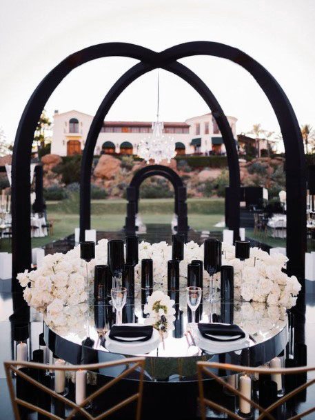 White Blossoms And Black Arch Wedding Decor