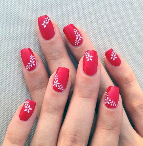 White Floral Art On Bright Red Nails For Women