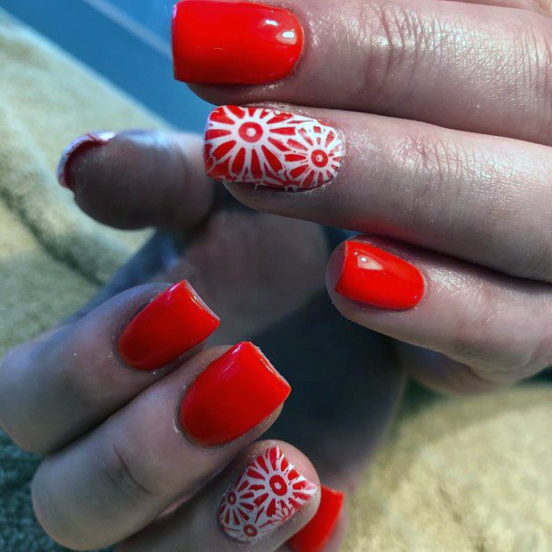 White Floral Art On Red Orange Nails For Women