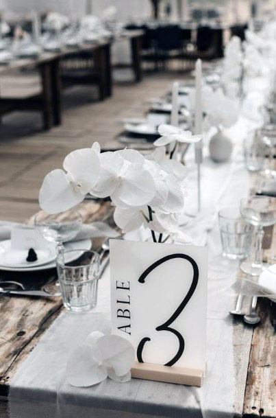 White Florals And Black Seat Card Wedding Decor