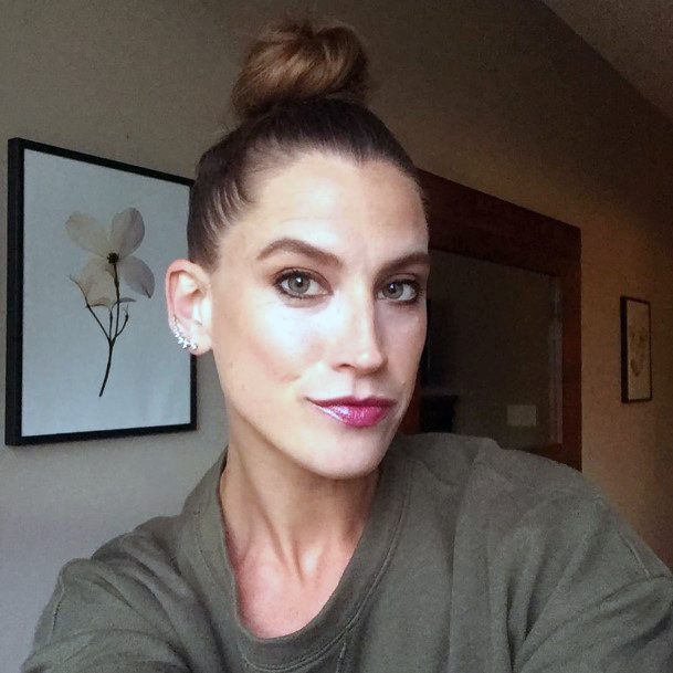 White Woman With Wooden Brown Hair In Tight Top Knot Hairstyle