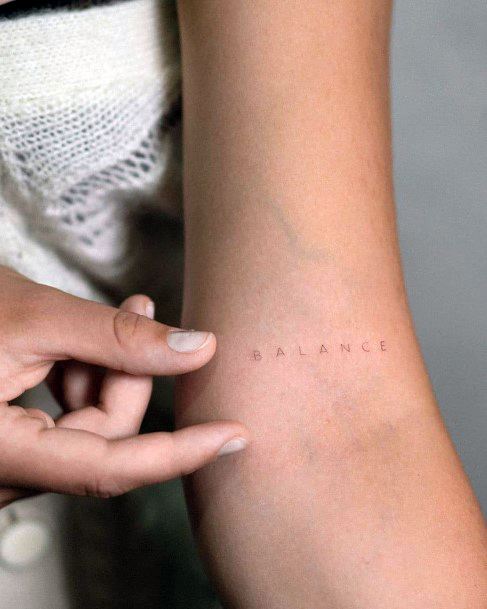 Woman With Balance Tattoo