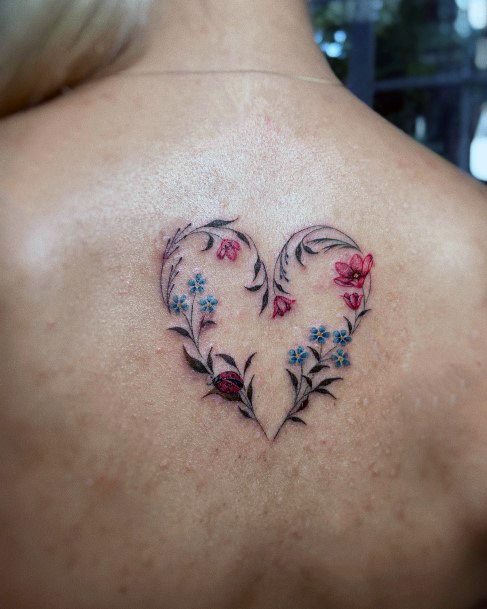 Woman With Fabulous Flower Heart Tattoo Design