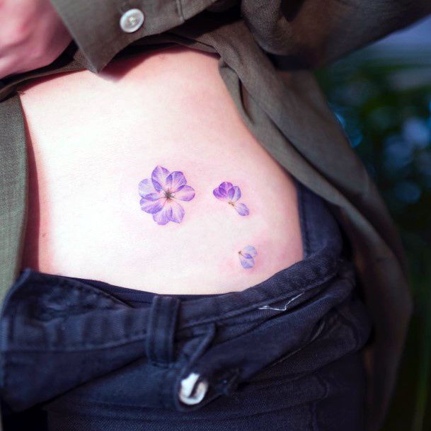 Woman With Fabulous Flower Petal Tattoo Design