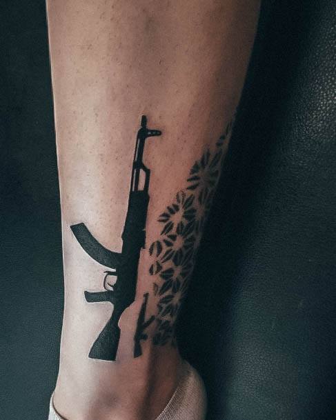 Woman With Fabulous Gun Tattoo Design