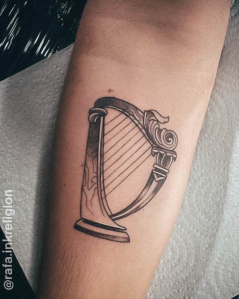 Woman With Fabulous Harp Tattoo Design