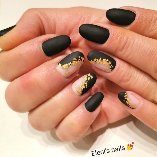 Woman With Fabulous Matte Black And Gold Nail Design