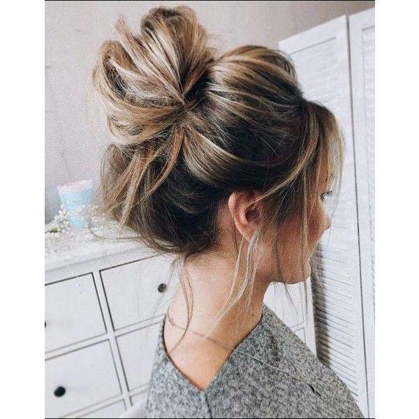 Woman With Long Golden Blonde Hair In Top Knot Hairstyle