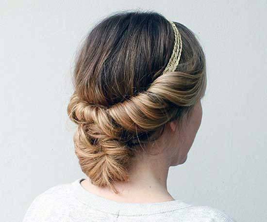 Woman With Medium Blonde Hair Twisted Into Low Bun