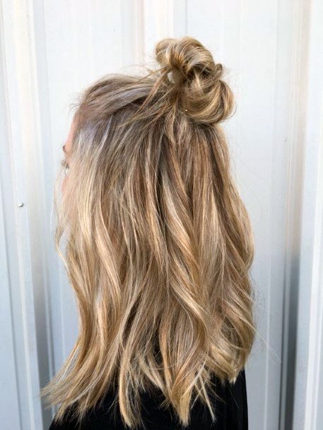 Woman With Medium Hair In Half Up Half Down Top Knot Hairstyle