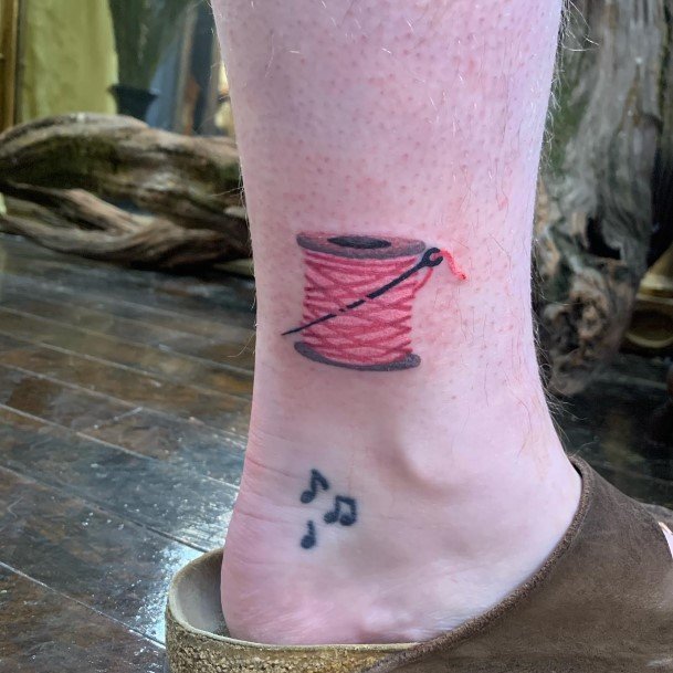 Woman With Needle And Thread Tattoo