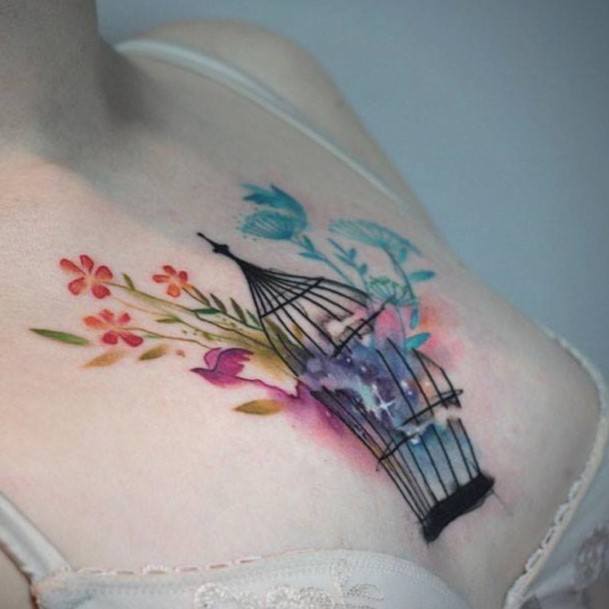 Women Chest Colored Flowers And Open Caged Tattoo