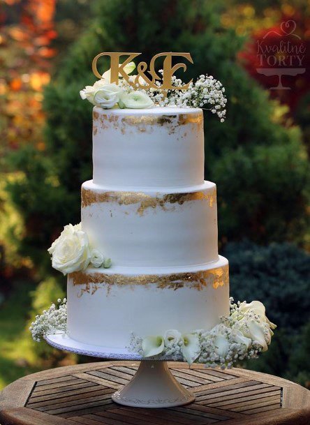 Womens Golden Art Work On Elegant Wedding Cake