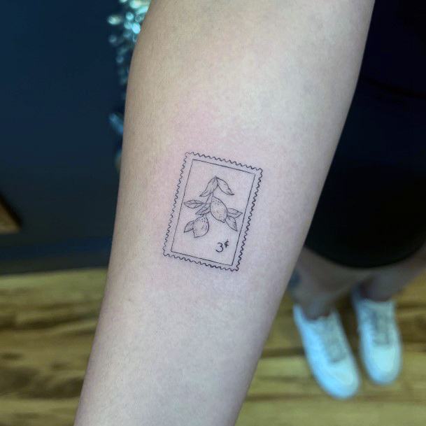 Tiny beach stamp tattoo located on the inner forearm