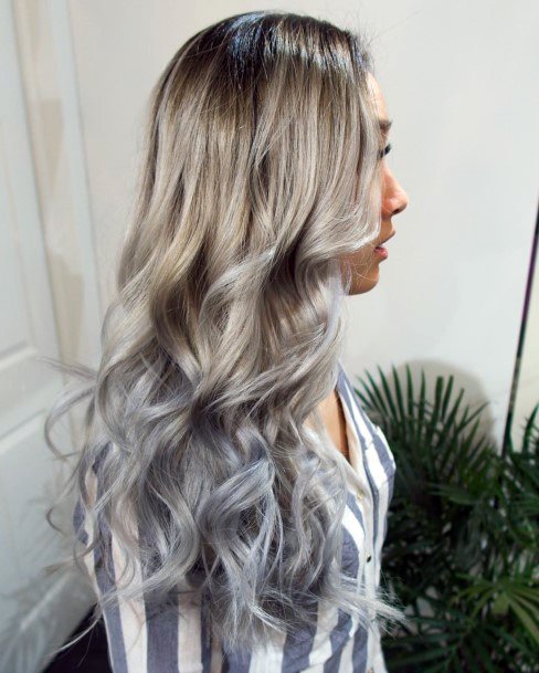 Young Woman With Straight Ending Wavy Grey Highlighted Hair Color